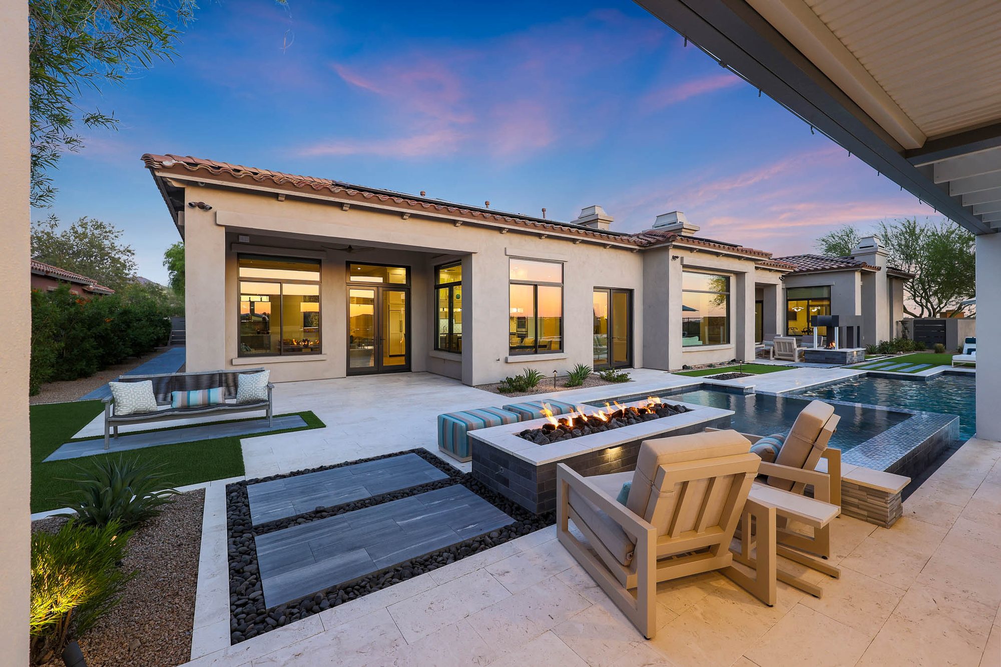 Backyard fire pit and pool at twilight