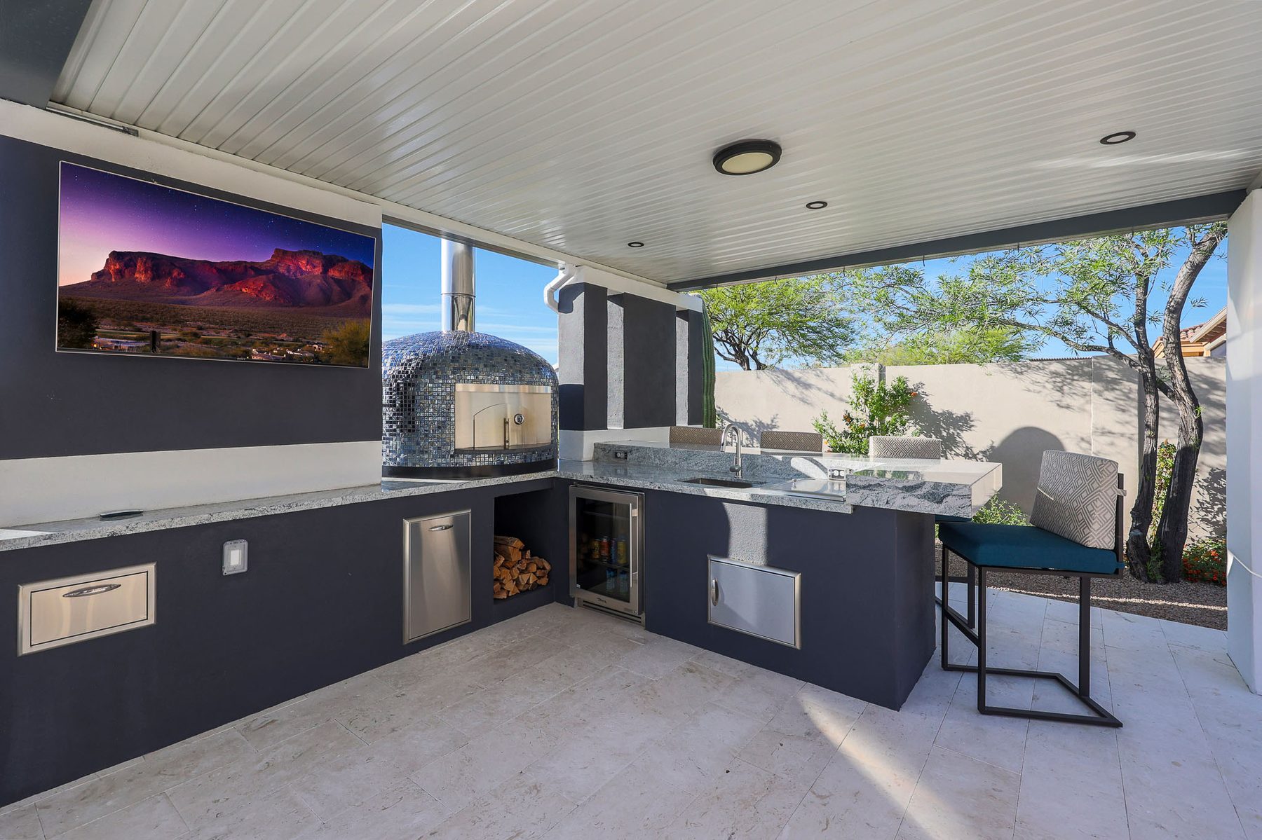 Outdoor kitchen with wood-burning pizza oven